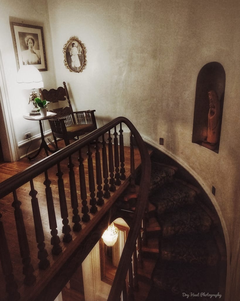 Interior shot of the upstairs landing and haunted rocking chair of the Luna Mansion.